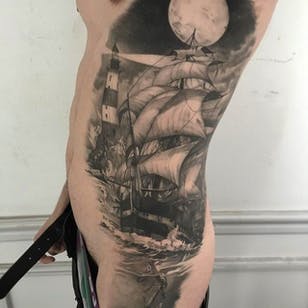 Tatuaje lateral enorme y sorprendente realizado por Ruben.  #Ruben #mikstattoo # gris de dientes negros # barco # faro #anclaje # costilla