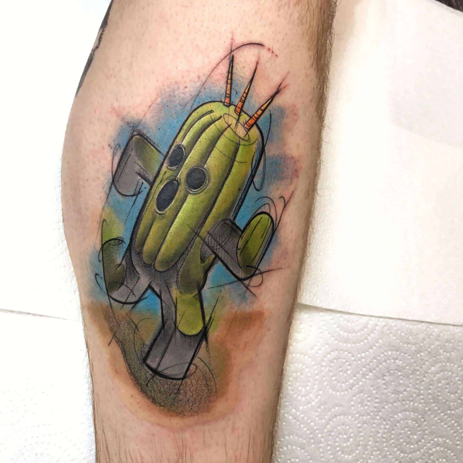 tatuaje de cactus en la pierna